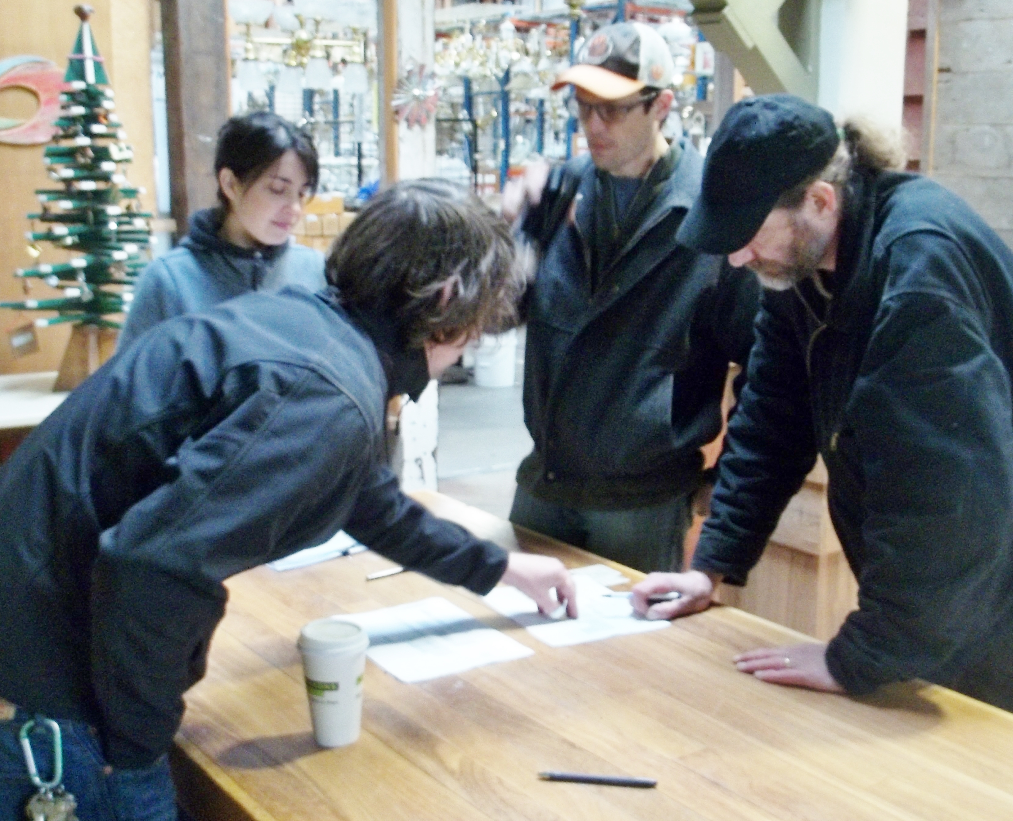 Lean Portland volunteers Chelsey McIntyre and Matt Horvat (back) work with Leif Amundson and Tom Patzkowski (front) at The Rebuilding Center to review possible layout changes in Portland, Oregon