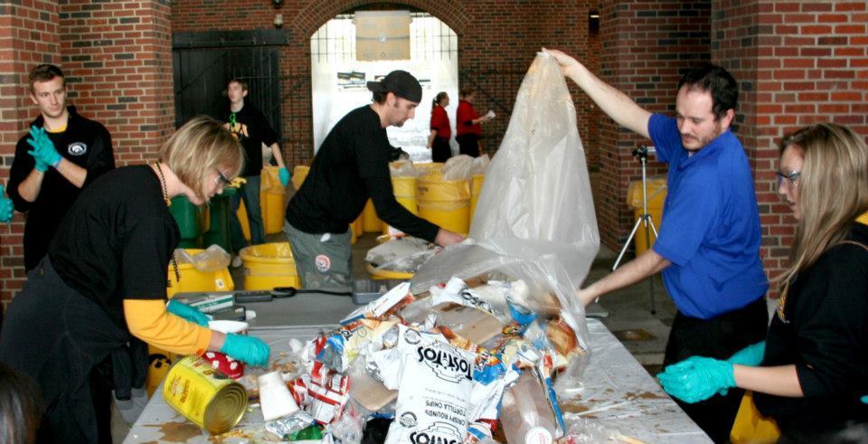 Volunteers perform a 'Dumpster Dive' waste audit after a football game in Kinnick Stadium at the University of Iowa in Iowa City, Iowa