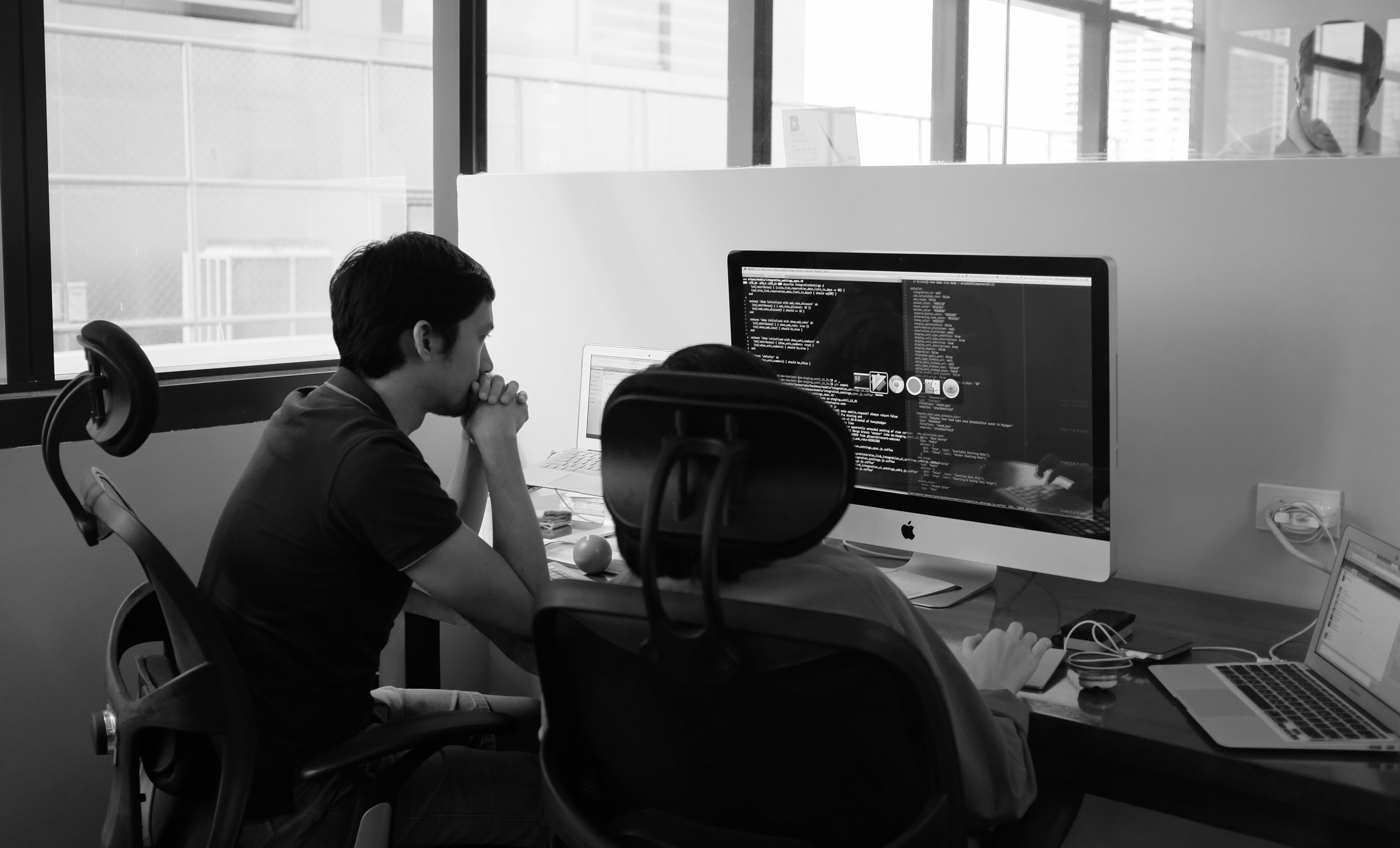 Ramon and Cecille pair-programming.  Ramon is navigating, Cecille is driving.