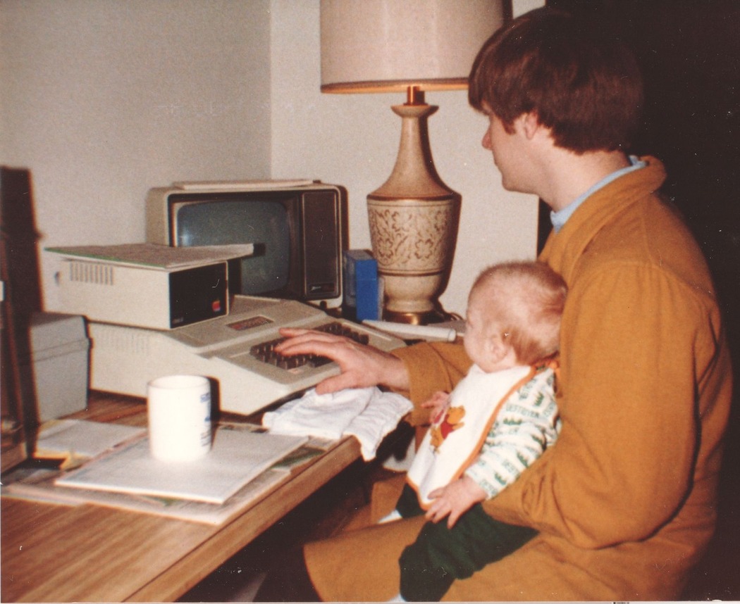 Author and Jakob seated at computer