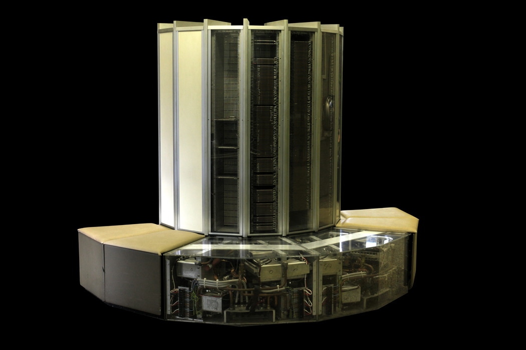 CRAY-1 system with see-through panels showing power supplies at the base and columns containing 144 modules each column