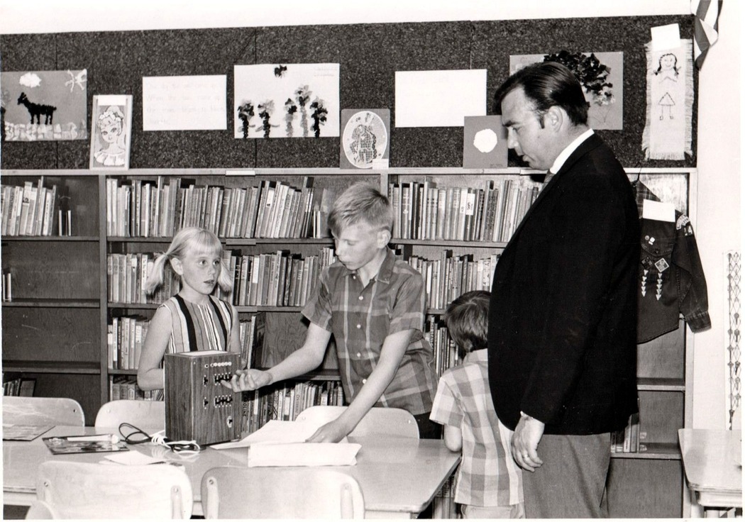 Ed demonstrating binary adder project, with sister Vicki at left